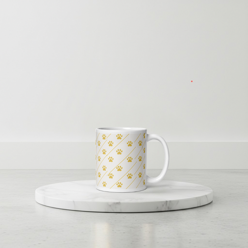 Ivory Whisper mug with gold paw print pattern on a marble coaster with a light gray background