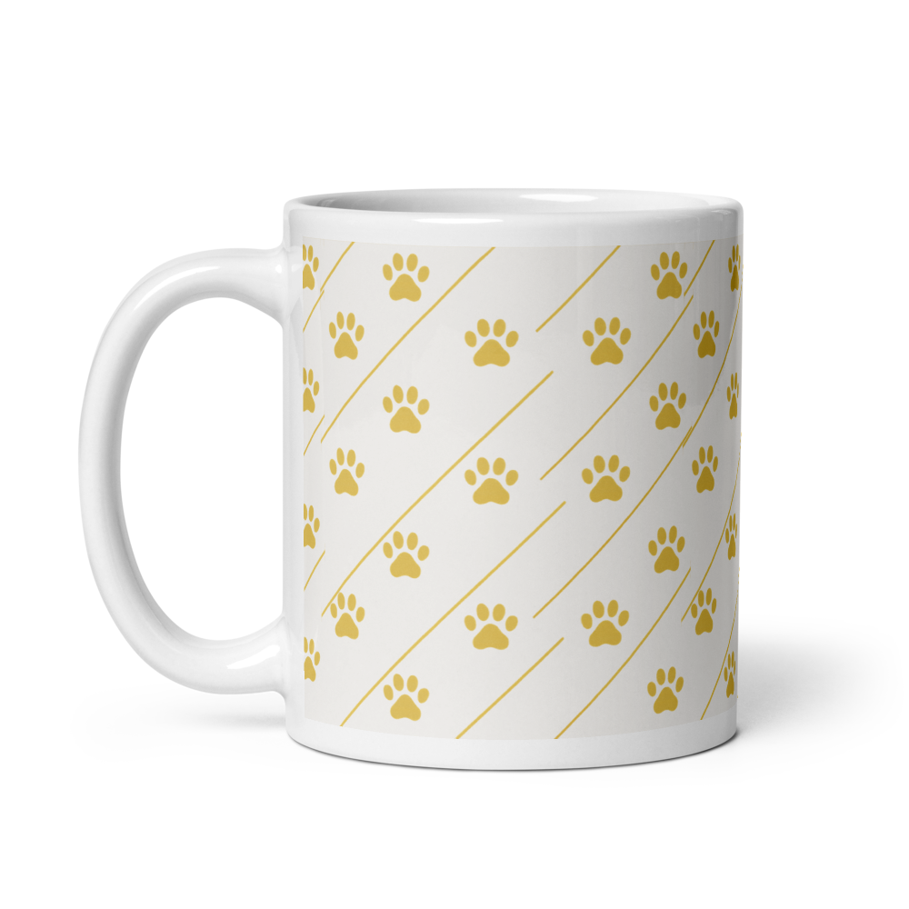 White mug with yellow paw print pattern on a white background