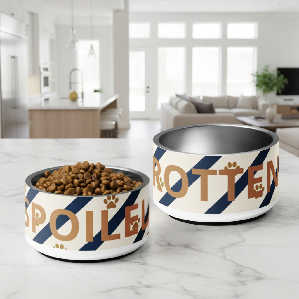 Two dog bowls with 'Spoiled' and 'Rotten' text on a marble surface.