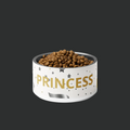 White bowl with 'PRINCESS' text filled with pet food on a black background