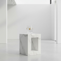 Marble-patterned side table with a small decorative item on a white background