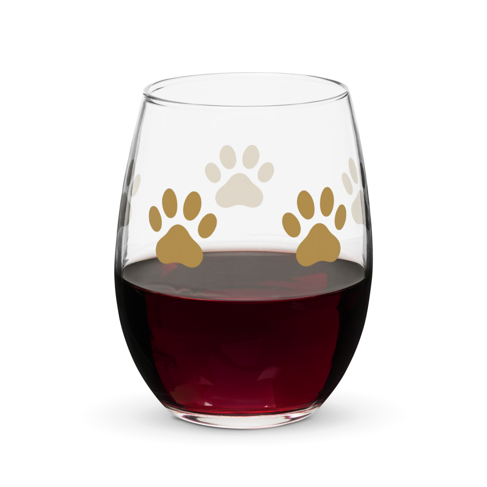Stemless wine glass with paw prints filled with red wine on a white background