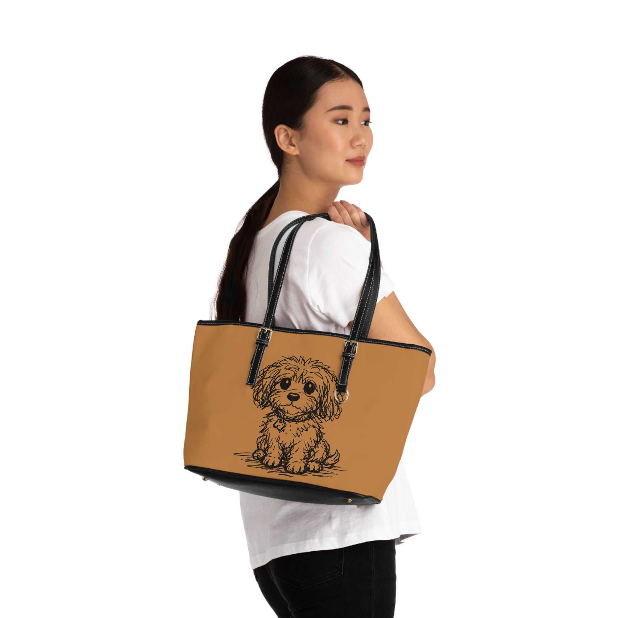 Woman holding a tan tote bag with a dog illustration on a white background