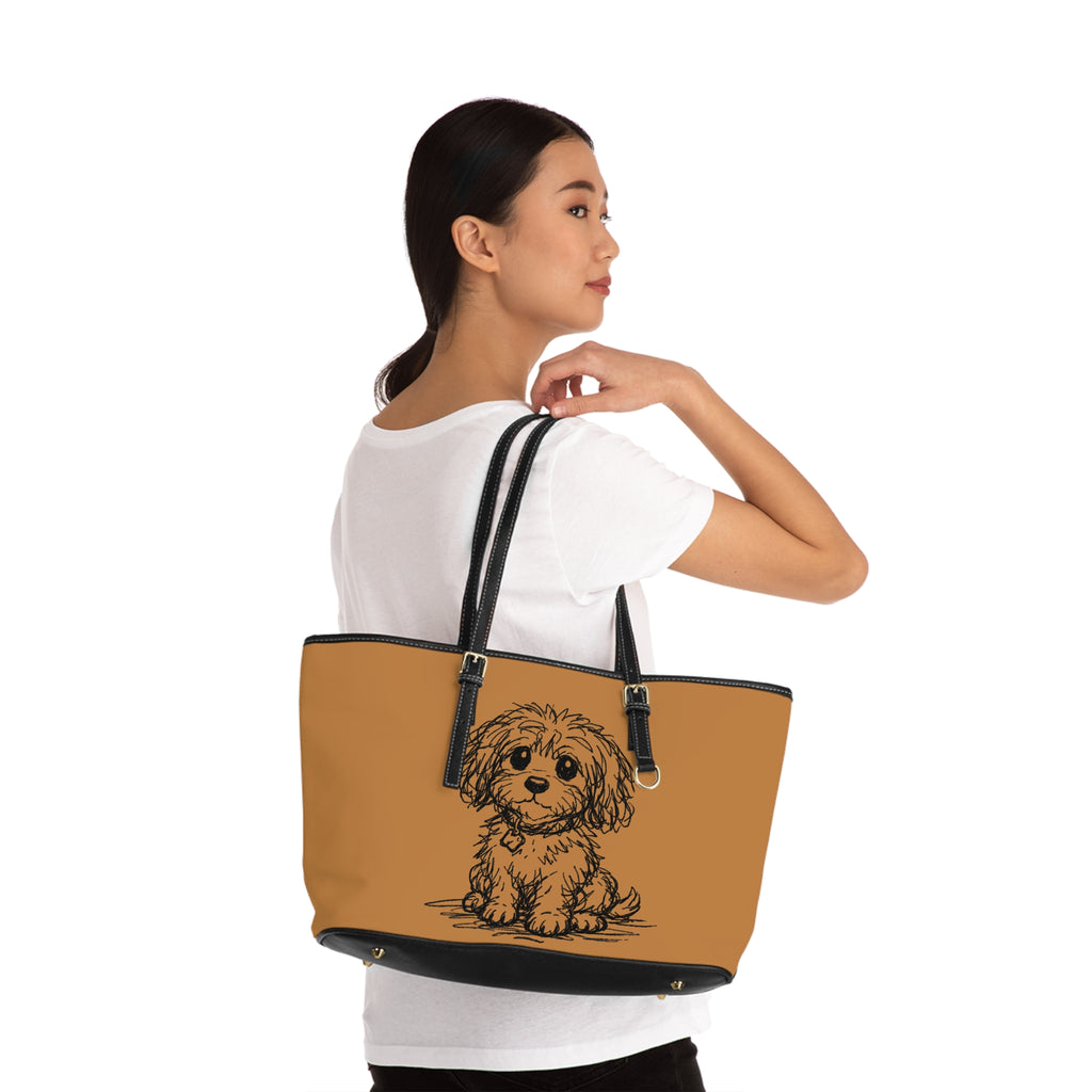 Woman holding a tan tote bag with a dog illustration on a white background