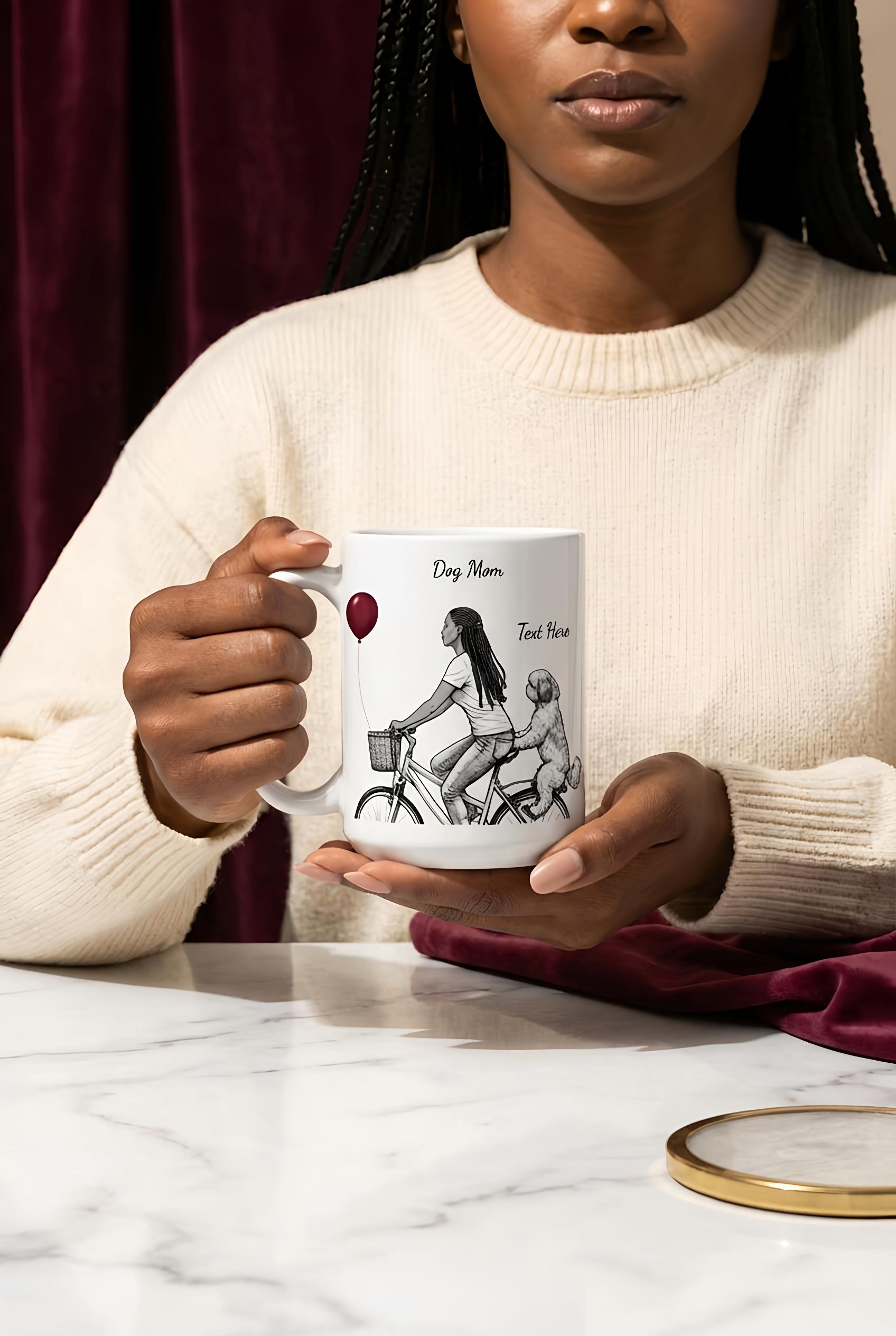 Person holding a mug with a design on a marble surface