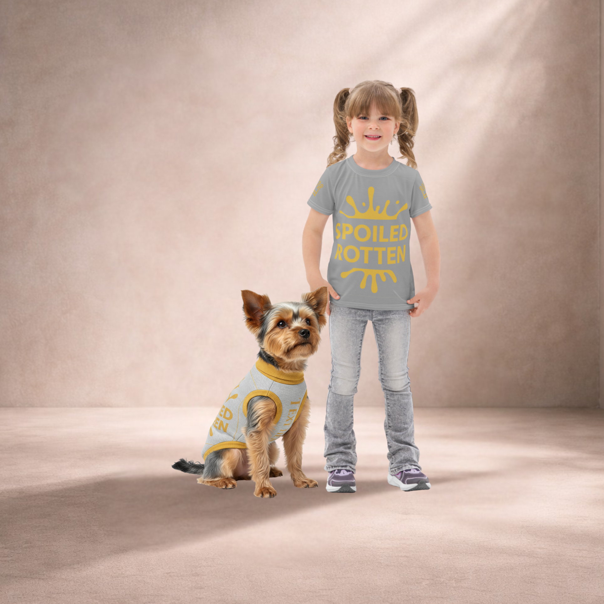 Girl and dog wearing matching gray outfits with yellow text on a beige background