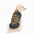 Dog wearing a blue and yellow shirt with text on a white background