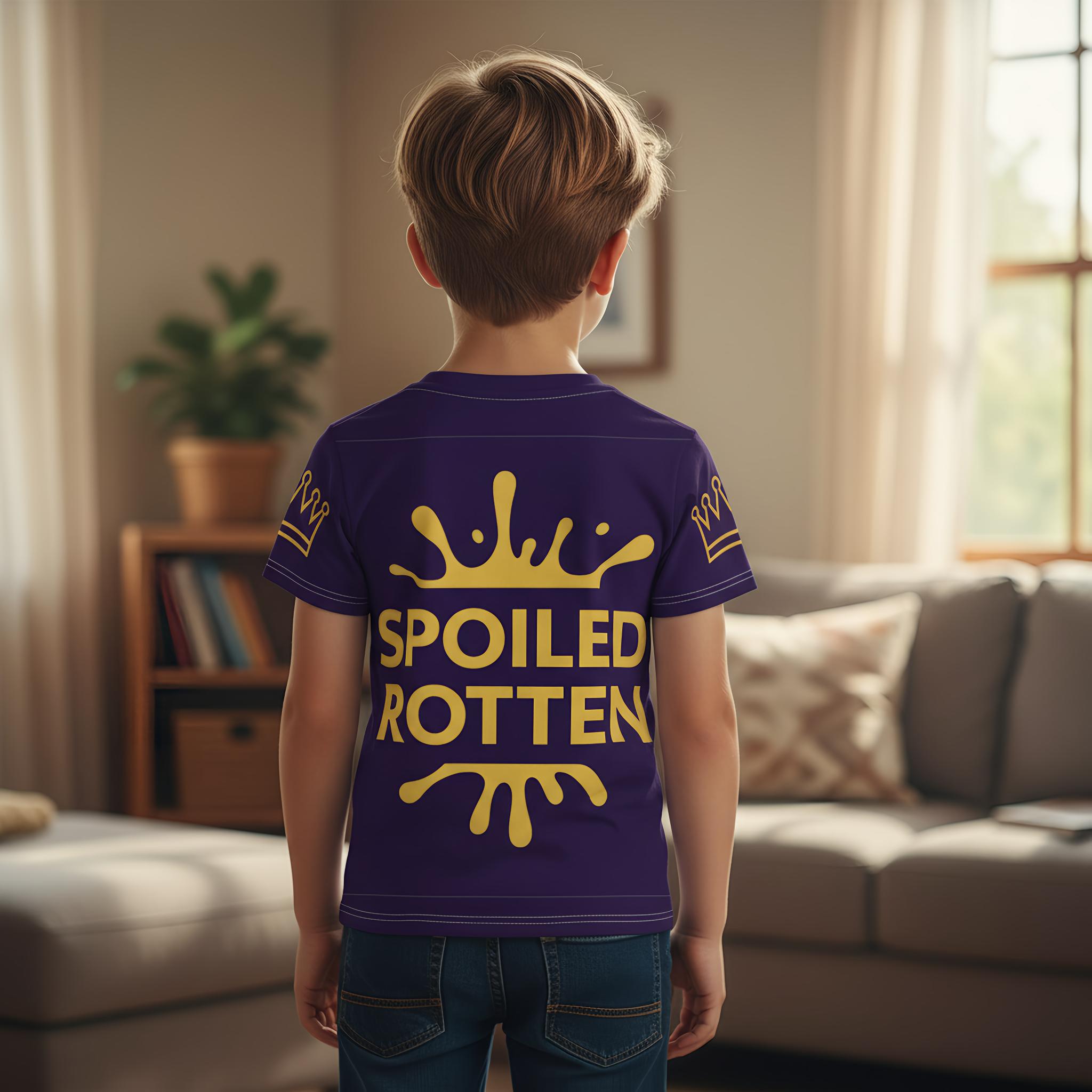 Child wearing a blue t-shirt with 'Spoiled Rotten' text in a living room.