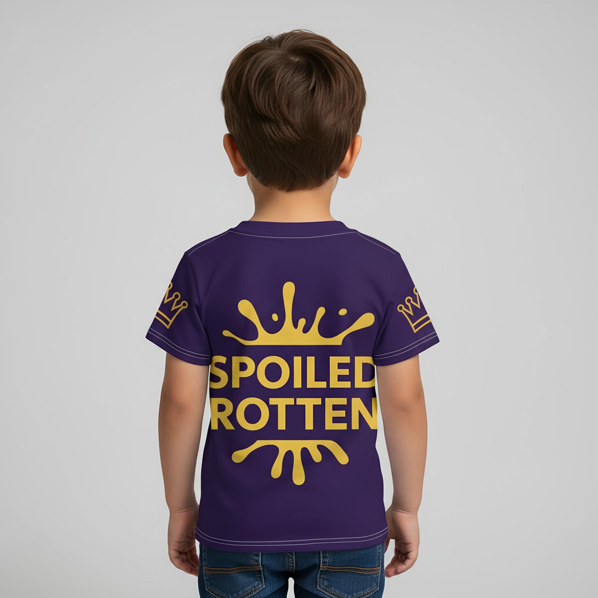 Child wearing a blue t-shirt with 'Spoiled Rotten' in gold text on a plain background
