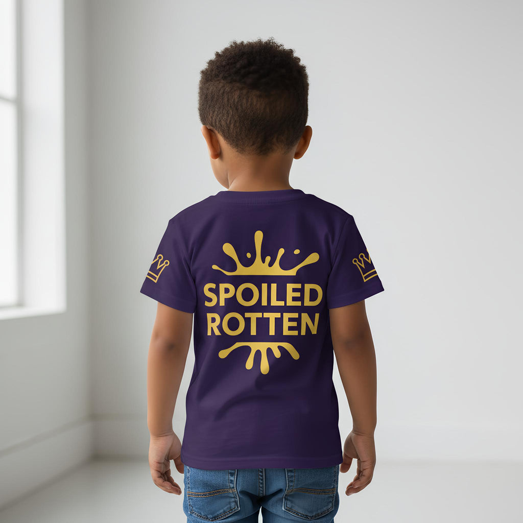 Child wearing a blue t-shirt with 'Spoiled Rotten' text and crown design on the back.
