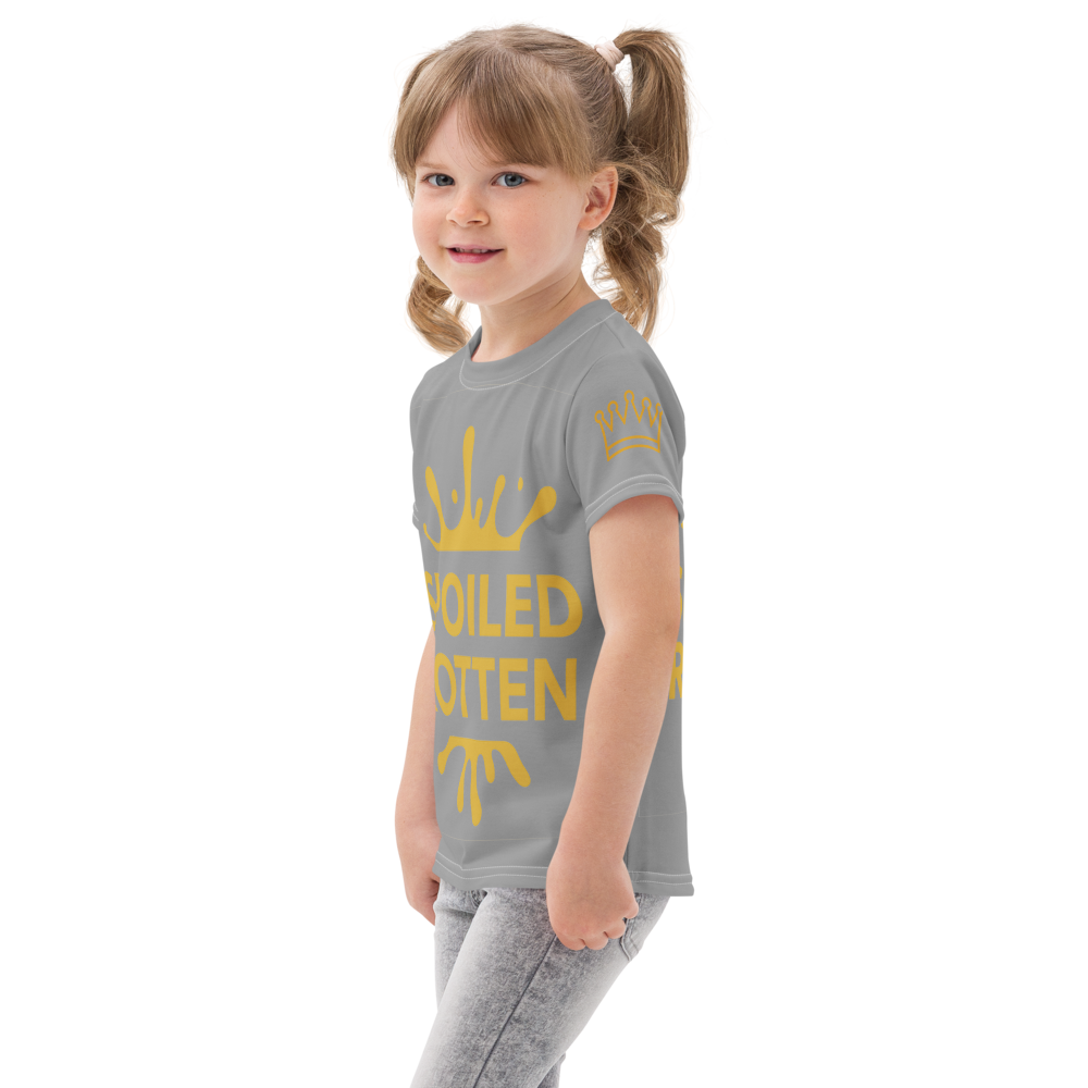 Child wearing a gray t-shirt with gold text and graphics on a white background