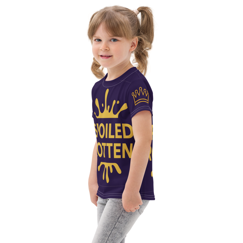 Child wearing a blue t-shirt with gold text and crowns on a white background