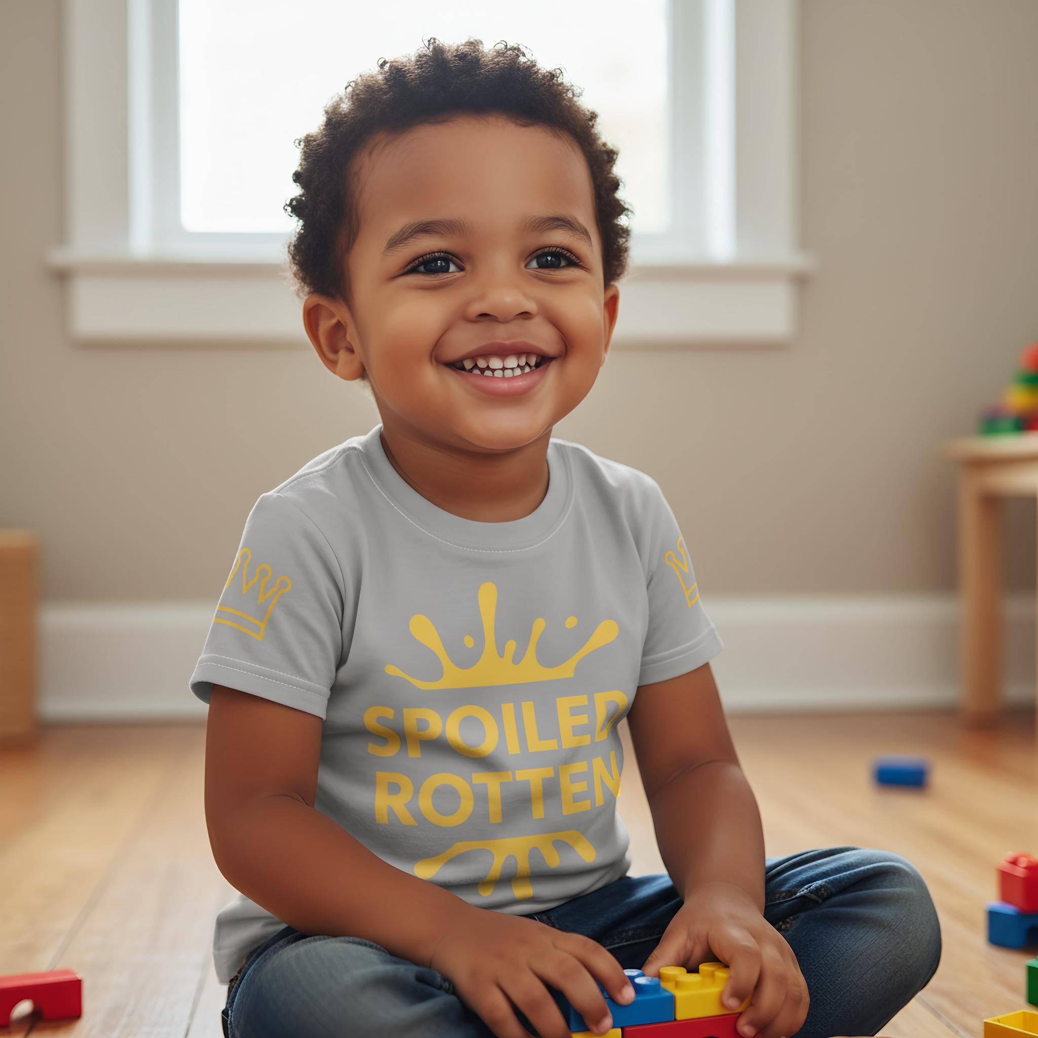 Child playing with toys indoors, wearing a shirt with text