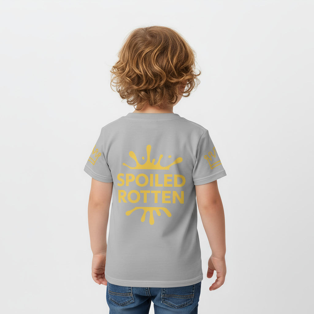 Child wearing a gray t-shirt with 'Spoiled Rotten' in gold on a plain background